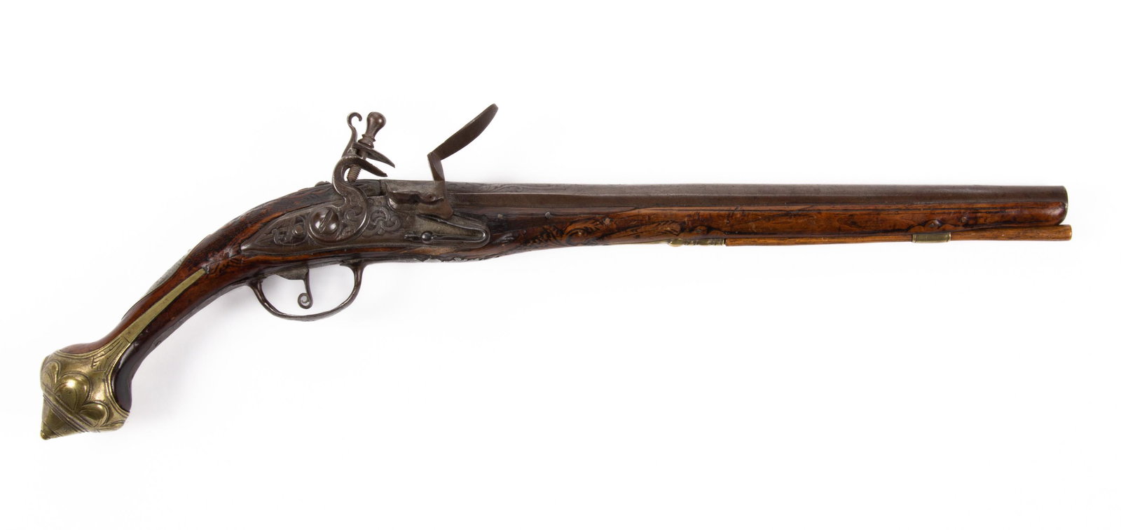 TURKISH CARVED FLINTLOCK PISTOL,: approximately .62 caliber, walnut stock with profuse relief carving, no markings located, replaced ramrod. 18th/19th century. 12 3/4" L barrel, 20 1/2" LOA. Provenance: Property from the estate of Dal