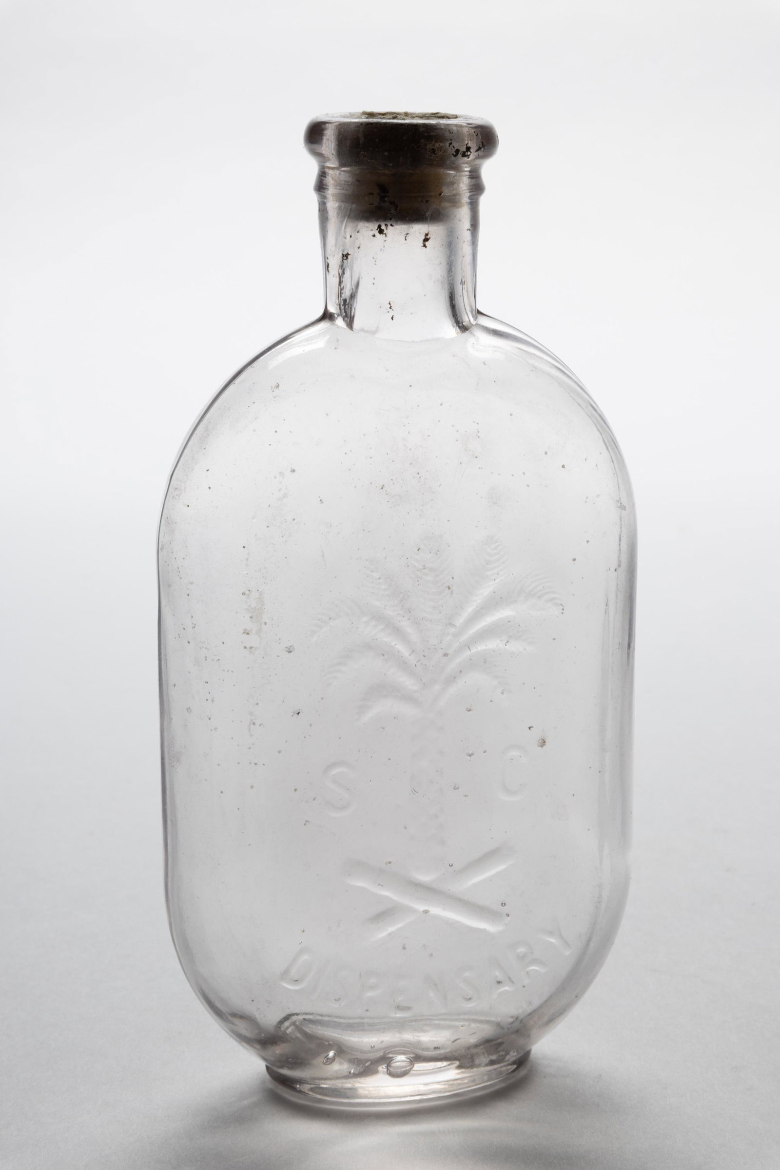 SOUTH CAROLINA DISPENSARY FLASK,: colorless, pint, embossed "S (palmetto tree) C / DISPENSARY", rounded collared mouth, smooth base. Fourth quarter 19th century. 6 3/4" H. Provenance: From the collection of Robert and Margaret Mayo, G