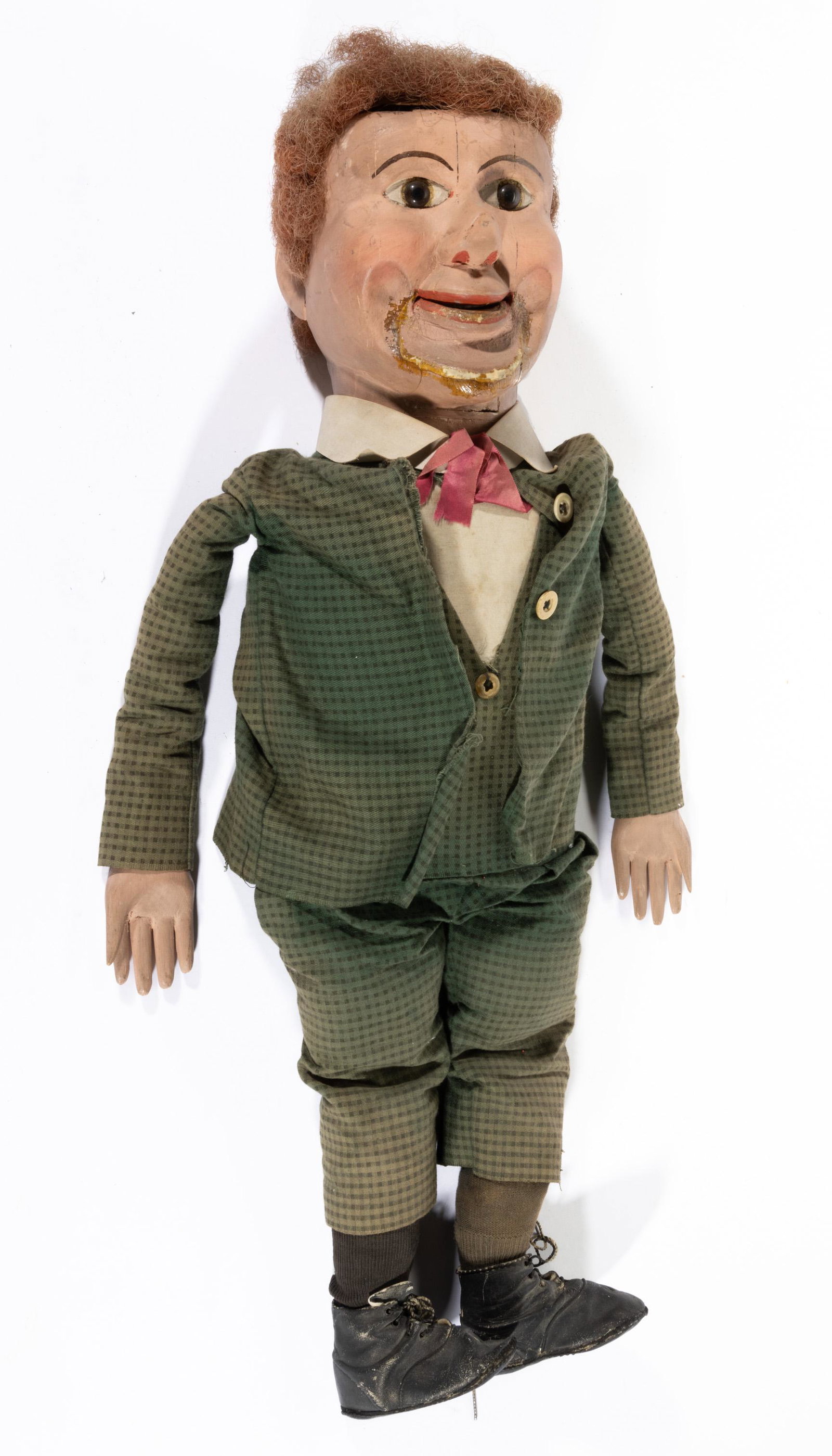 AMERICAN FOLK ART CARVED AND PAINTED VENTRILOQUIST DOLL / DUMMY,: featuring applied glass eyes, with carved wooden face and hands, fitted in period attire. First quarter 20th century. 30" H. Provenance: From an important New York private collection.