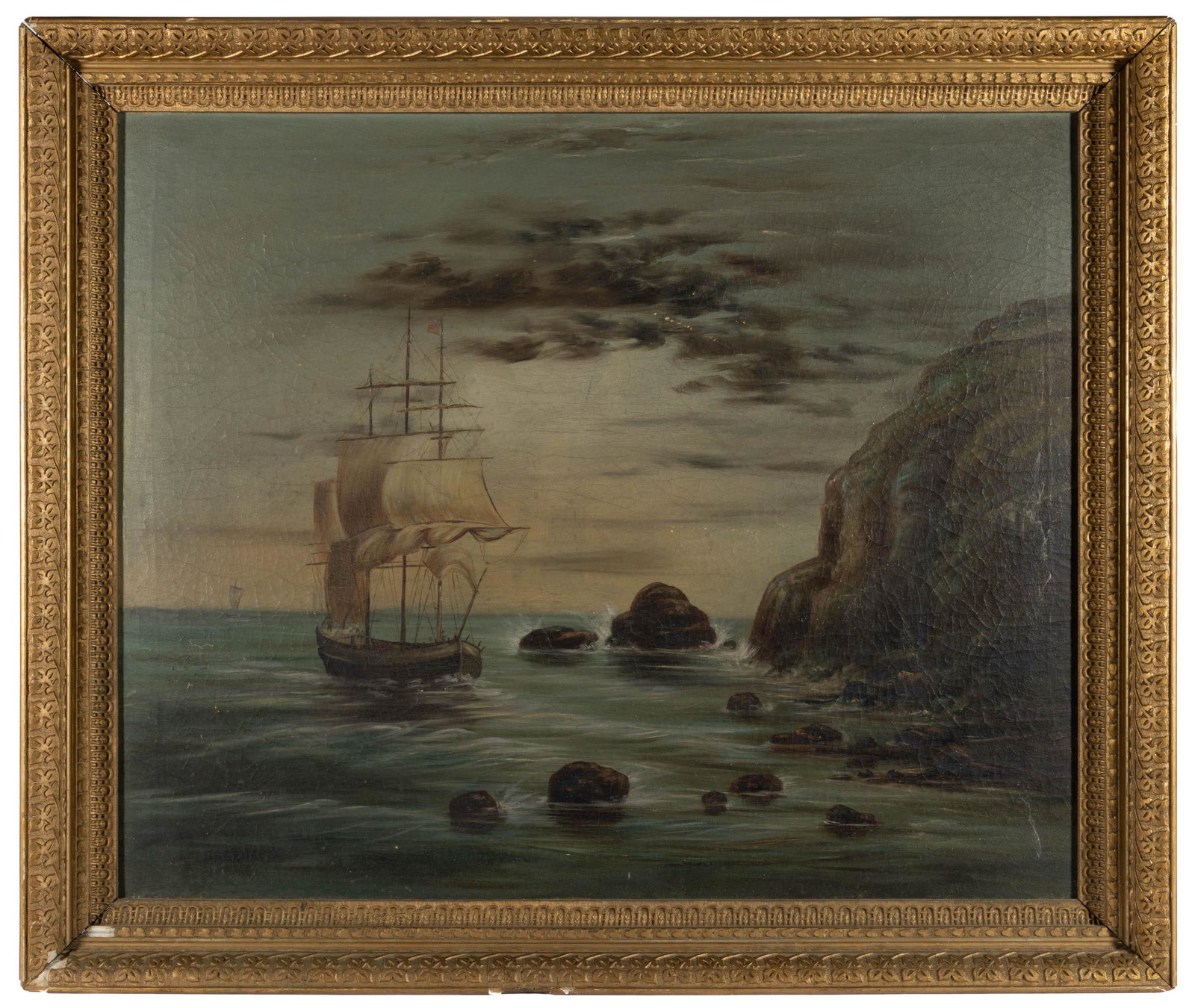 AMERICAN SCHOOL (19TH CENTURY) FOLK ART NAUTICAL PAINTING,: oil on canvas, depicting a three mast sailing vessel flying the American flag near a rocky shoreline and dark clouds in the background, no signature located. Housed in likely original gilt molded fram