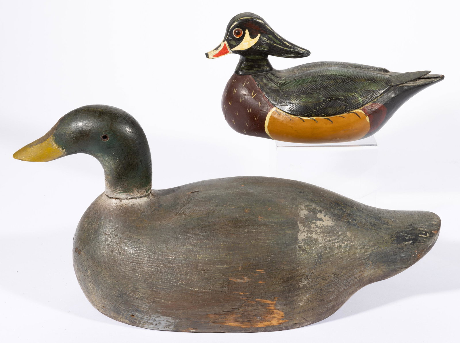 HANK BROOKS (VIENNA, VIRGINIA) FOLK ART CARVED AND PAINTED WOOD DUCK DECOY,: signed to the underside "HANK / BROOKS / VIENNA, / VA." Retains original polychrome painted surface. Together with a solid body mallard decoy. Two pieces total. 20th century. 6 1/2" HOA, 12" LOA.