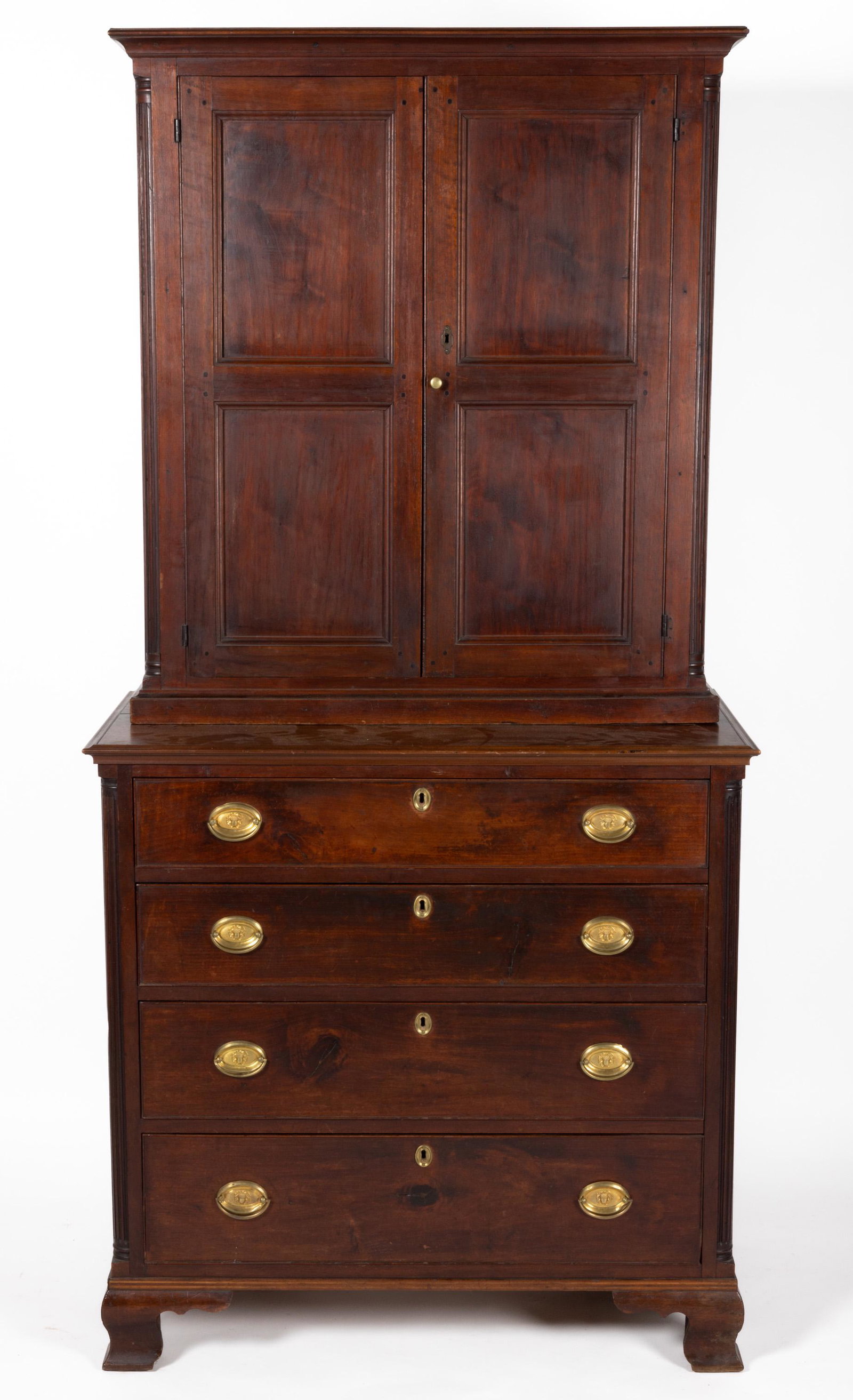 PENNSYLVANIA CHIPPENDALE WALNUT BOOKCASE OVER CHEST OF DRAWERS,: two-piece construction, upper case with applied cornice over two hinged fielded panel doors concealing two fixed shelves flanked by fluted columns, lower section with four graduated drawers with perio