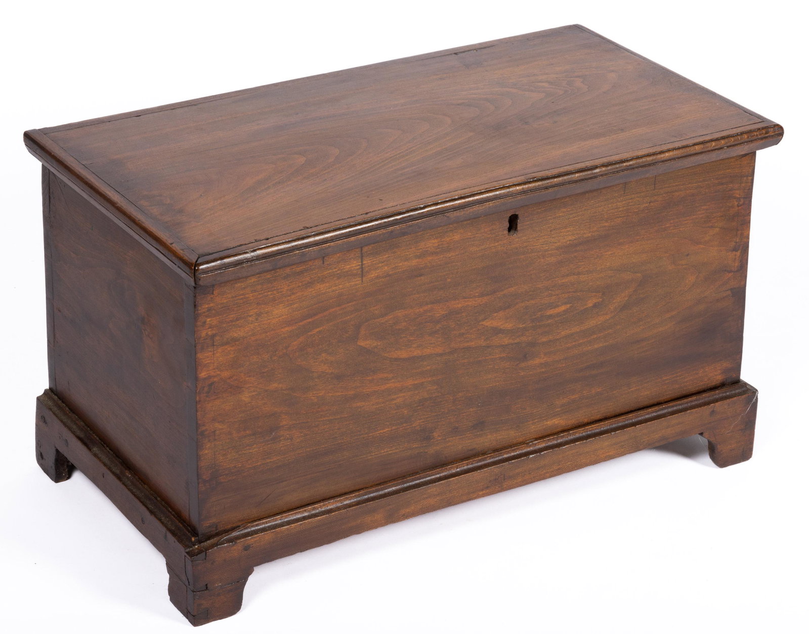 MID-ATLANTIC POPLAR MINIATURE BLANKET CHEST,: hinged rectangular lid with applied edged molding, over dovetailed case with lidded till, raised on bracket feet. Oak secondary wood. Retains an old surface with warm color. First half 19th century. 1