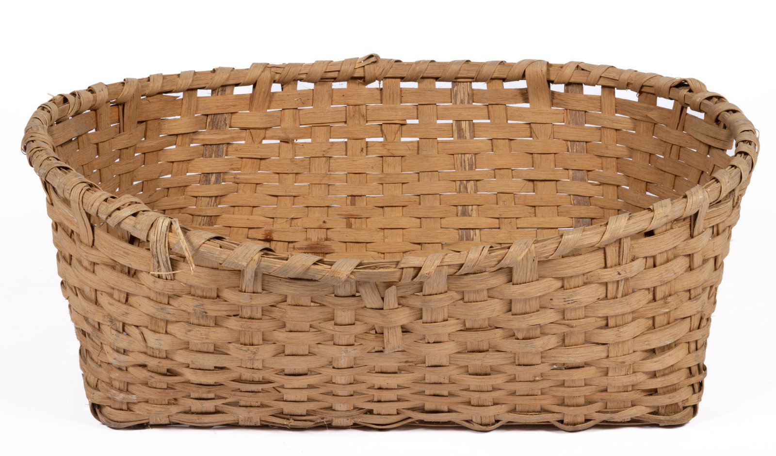 SOUTHERN STAVE-TYPE WOVEN-SPLINT LARGE BASKET,: with wrapped rim having two handles. Retains original dry natural surface. First half 20th century. 12" H, 25 1/4" x 31 1/4" OA. Provenance: From the collection of Katy and Jim Sheppard, Weston, WV.