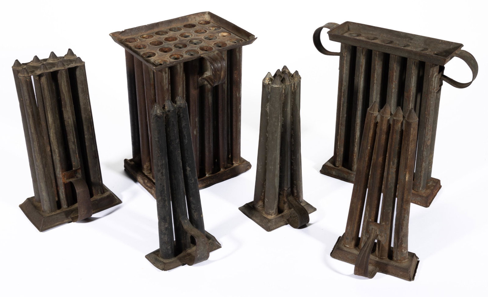SHENANDOAH VALLEY OF VIRGINIA SHEET-IRON / TIN TAPERED-FORM CANDLE MOLDS, LOT OF SIX,: including a 12-tube example and one example with an old D-shape handle make-do. 19th century. One 11" H. Provenance: Sold to benefit the acquisition and conservation funds of a private Virginia museum