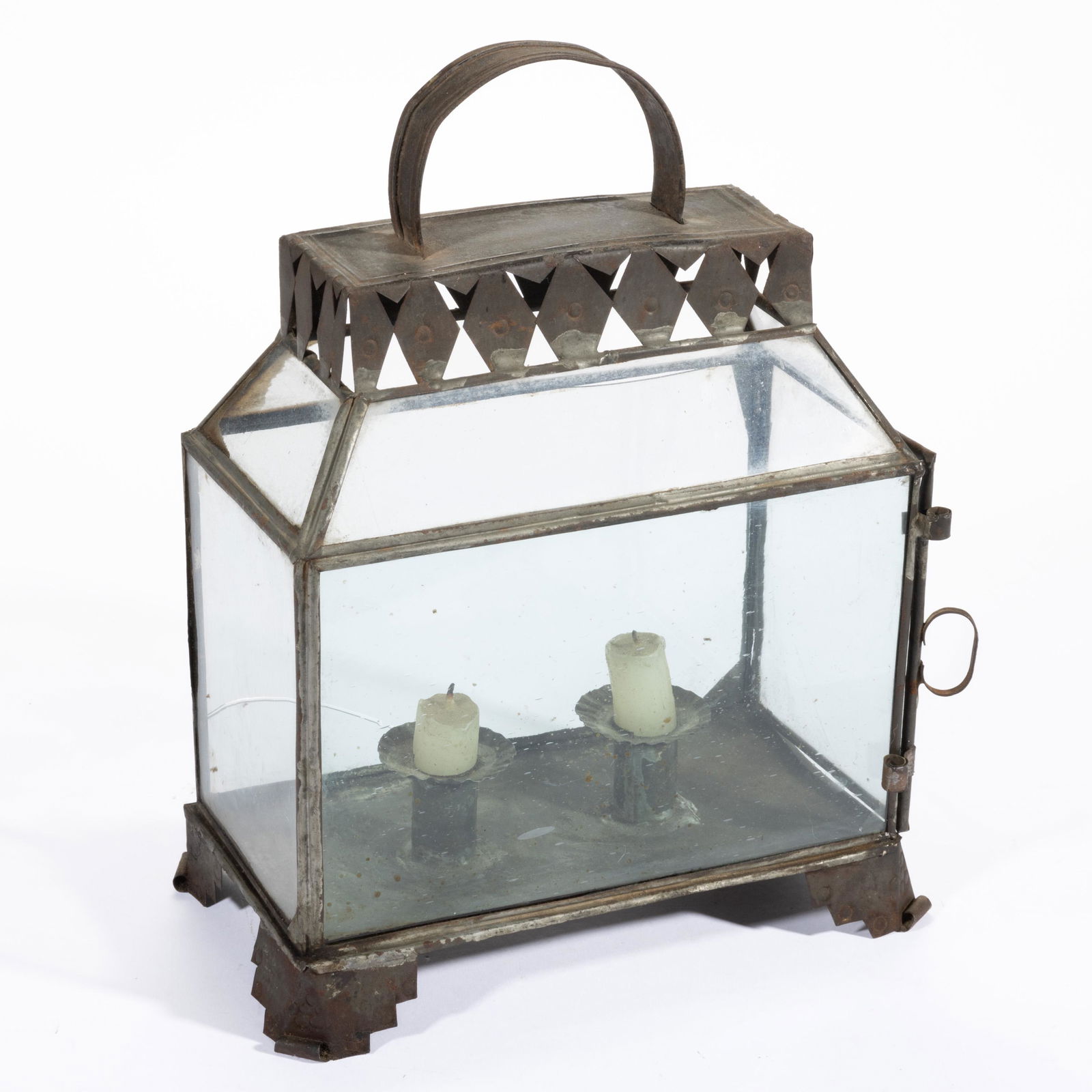SHEET-IRON DOUBLE-SOCKET CANDLE LANTERN,: rectangular form raised on four stylized legs with pressed circle pattern and curled tips, body with four glass panes including one end with a hinge for door, topped by four shaped glass panes, sheet-