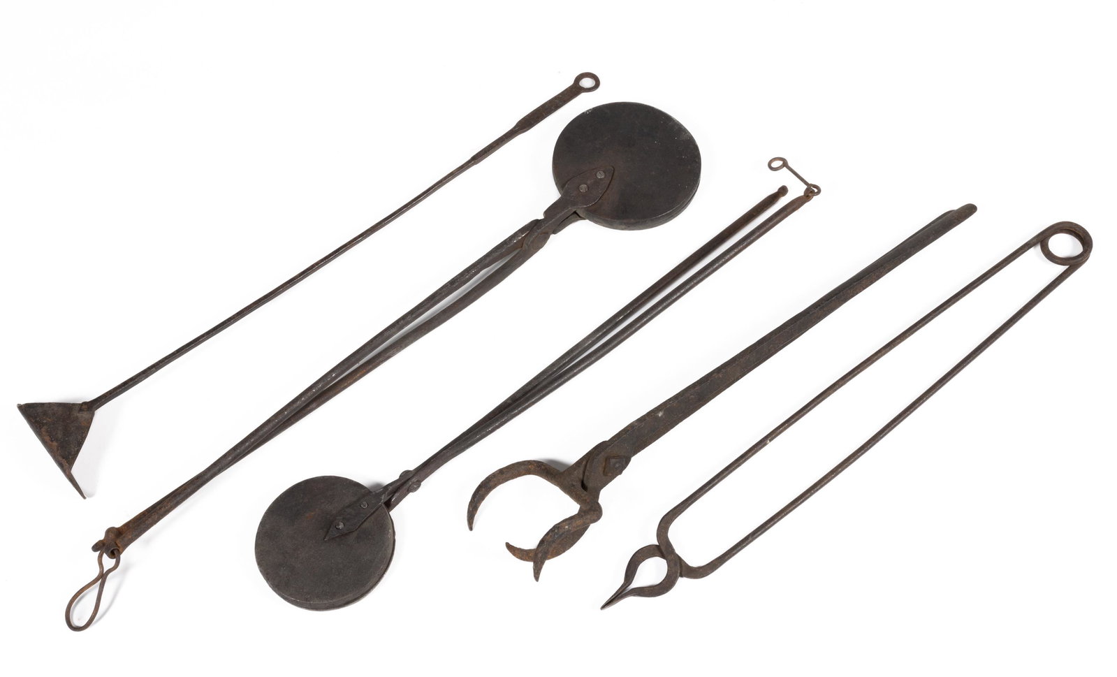 ASSORTED WROUGHT AND CAST IRON HEARTH ARTICLES, LOT OF FIVE,: comprising two wafer irons, each with a circular-form plate and stylized foliage pattern; a log gripper, a rake for coals/ashes with handle terminating in a loop, and a pair of tongs with spring activ