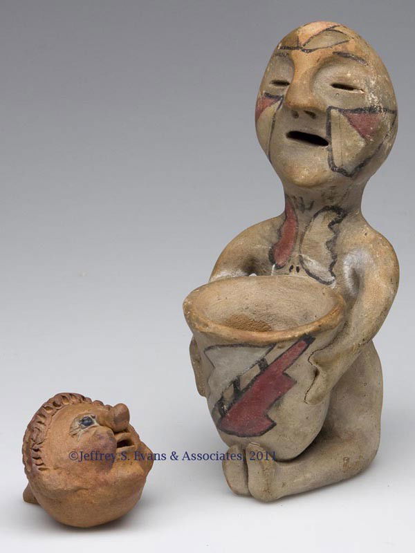 TWO EARTHENWARE FIGURAL OBJECTS: TWO EARTHENWARE FIGURAL OBJECTS, comprising a Pueblo Tesuque Rain God figure and a head-form whistle with glazed eyes and an illegible signature. 19th or 20th century. 2" and 6" H.