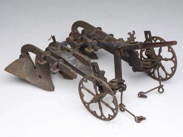 RARE TEXAS HORSE-DRAWN PLOW MODEL: RARE TEXAS HORSE-DRAWN PLOW MODEL, possibly a patent model, cast-iron and wood, four shovels, pewter plaque engraved "Thomas L. Thrasher, Paris, Lamar County, Texas, June 25th, 1849", original surface