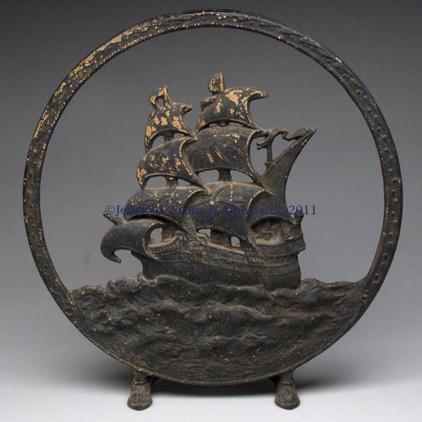 CAST-IRON CONE RADIO SPEAKER FRAME: CAST-IRON CONE RADIO SPEAKER FRAME, depicting a sailing ship, rear mounting holes for speaker. First half 20th century. 17 1/2" D.