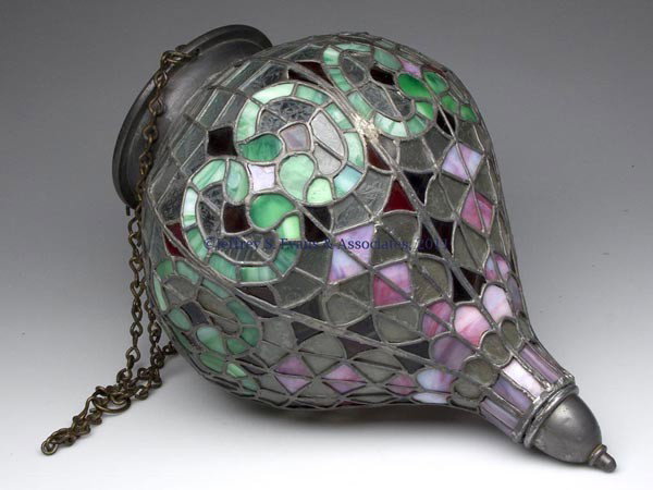 LEADED GLASS HANGING APOTHECARY SHOW GLOBE: LEADED GLASS HANGING APOTHECARY SHOW GLOBE, tear-drop shape set with different color slag and etched glass pieces, period brass chain probably original. Late 19th/early 20th century. 17" H globe, 6 3/