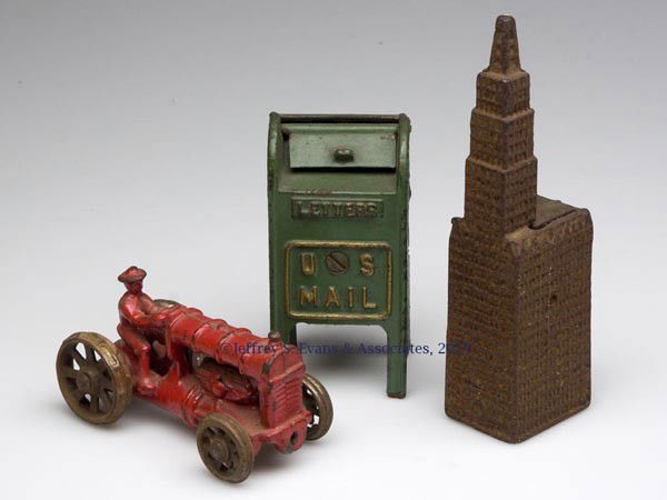 THREE ASSORTED CAST-IRON TOYS: THREE ASSORTED CAST-IRON TOYS, comprising a farm tractor with nickel wheels and two banks. First half 20th century. 2" to 5 3/4" H. Provenance: From the estate of R. Merlin Turner.