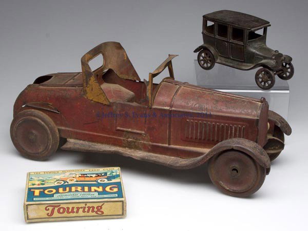 THREE AUTOMOBILE RELATED TOYS: THREE AUTOMOBILE RELATED TOYS, comprising a cast-iron Arcade four-door sedan, a pressed steel friction drive roadster, and a Touring card game. First half 20th century. 6 1/2" to 17" L. Provenance: Fr