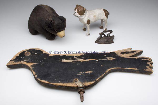 FOUR ASSORTED TOYS: FOUR ASSORTED TOYS, including a papier mache bull dog on tin wheels. First half 20th century. Dog 5 1/4" H.
