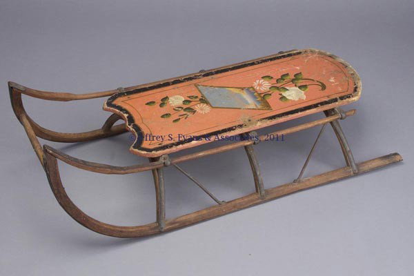 PAINT DECORATED CHILD'S SLED: PAINT DECORATED CHILD'S SLED, wooden with iron runner blades and braces, original polychrome paint. Fourth quarter 19th century. 11" HOA, 34" LOA. Provenance: From a Pennsylvania private collection.