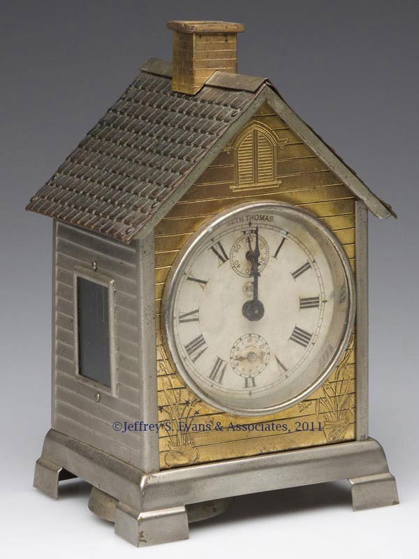 SETH THOMAS FIGURAL ALARM CLOCK: SETH THOMAS FIGURAL ALARM CLOCK, in the form of a cottage. Late 19th century. 7" H. Provenance: From the collection of Pat and the late Bob Costa.