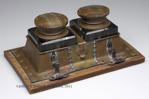 AMERICAN ARTS AND CRAFTS HAMMERED COPPER AND SILVE: AMERICAN ARTS AND CRAFTS HAMMERED COPPER AND SILVER INKSTAND, original square glass wells and laminated oak base, marked on edge "COPPER AND SILVER", no other markings located. Probably J. C. Grogan, 