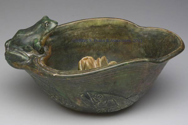 WELLER COPPERTONE FROG AND FISH BOWL: WELLER COPPERTONE FROG AND FISH BOWL, helmet-form bowl with frog perched on rim and fish molded on sides, with a related water-lily form flower frog. Both pieces with Weller Pottery arched stamp. Firs
