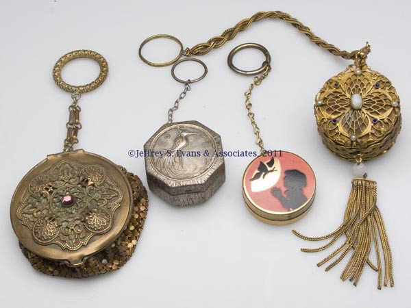 FOUR LADY'S COMPACTS: FOUR LADY'S COMPACTS, two set with jewels, one with mesh bag, each with finger ring. Jeweled examples possibly Austrian. First half 20th century. 1 1/2" to 2 1/2" D. Provenance: Collection of Allison 