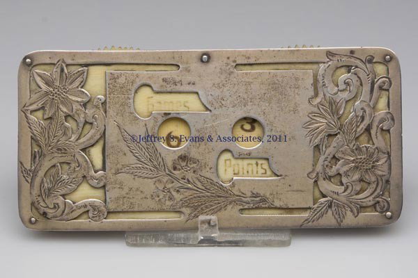 STERLING SILVER GAME COUNTER: STERLING SILVER GAME COUNTER, open-work ornamentation with celluloid number wheels indicating Games and Points, marked for R. Wallace & Sons, monogram on reverse. Late 19th/early 20th century. 1 3/4" 