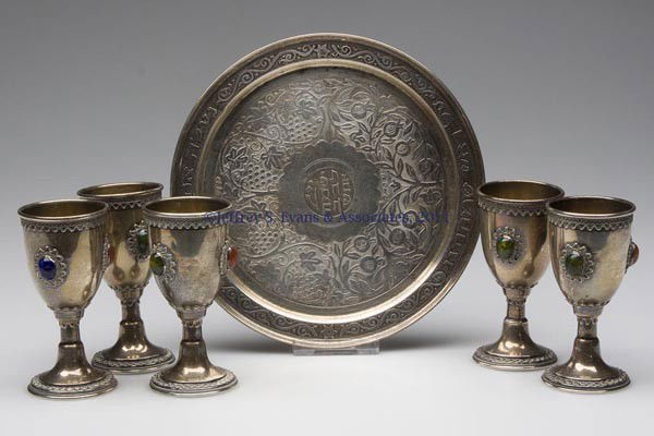 ISRAELI STERLING SILVER WINE CUPS AND TRAY: ISRAELI STERLING SILVER WINE CUPS AND TRAY, six pieces, comprising five jeweled wine cups, each set with three stone cabochons, and a small tray bearing Hebrew inscriptions. Each piece marked "ZADOK /