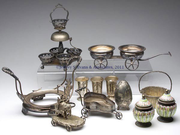 ASSORTED NOVELTY SILVER-PLATE ARTICLES AND OTHERS,: ASSORTED NOVELTY SILVER-PLATE ARTICLES AND OTHERS, LOT OF 12, including a Pairpoint bride's basket stand, a caster stand with bell, etc. 19th and 20th century. Provenance: From the collection of Pat a