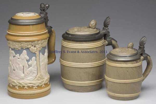 THREE METTLACH CERAMIC STEINS: THREE METTLACH CERAMIC STEINS, comprising a .5L #812, and a .25L and .50L #675, each relief molded with inlay lid and full base markings. Late 19th/early 20th century. 4 1/4" to 6 3/4" H to top of lid
