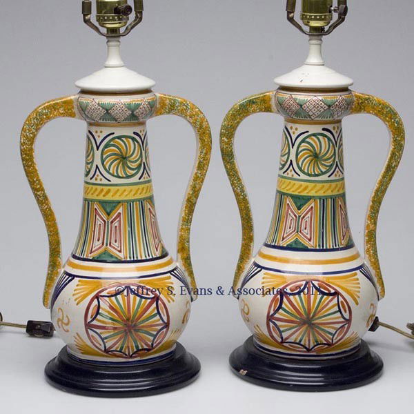 PAIR OF QUIMPER CERAMIC VASES MOUNTED AS TABLE LAM: PAIR OF QUIMPER CERAMIC VASES MOUNTED AS TABLE LAMPS, each with two handles and decorated in bright polychrome colors, with fabric shades. 20th century. Vases 12" H. Provenance: Property of a Georgia