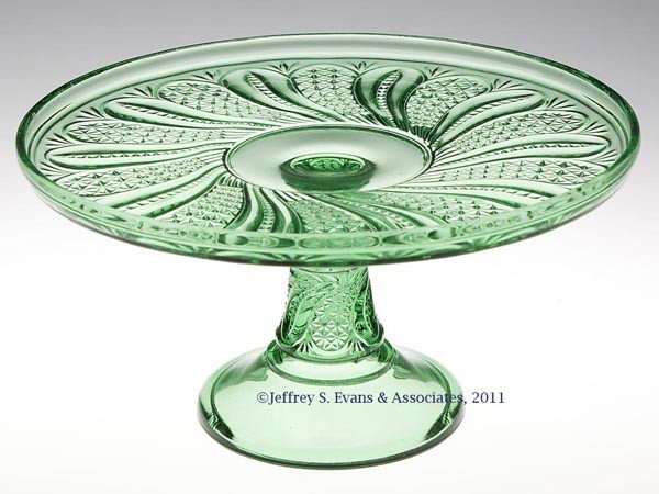 FEATHER CAKE STAND: FEATHER CAKE STAND, green. Late 19th/early 20th century. 5" H, 9 3/4" D. Provenance: Personal collection of Judith (Judy) Cronin, Orleans, MA.