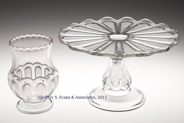 TEXAS / LOOP WITH STIPPLED PANEL TABLE ARTICLES, L: TEXAS / LOOP WITH STIPPLED PANEL TABLE ARTICLES, LOT OF TWO, colorless, comprising a cake stand and a celery vase. Fourth quarter 19th century. 6 1/4" H, 10 1/4" D, and 6" H.