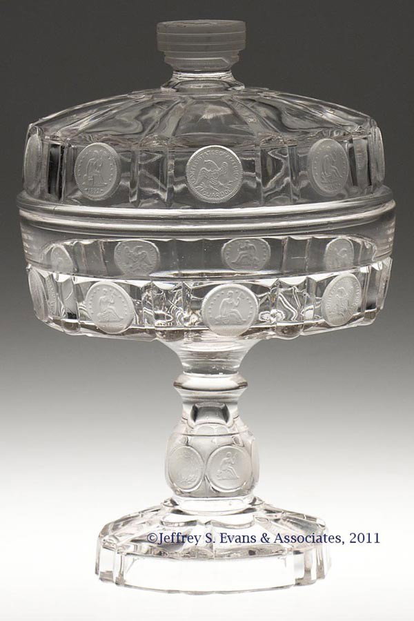 U. S. COIN COVERED COMPOTE: U. S. COIN COVERED COMPOTE, colorless with frosted coins, dollar finial, quarter-dollars on cover and bowl, dimes on stem. Central Glass Co. Fourth quarter 19th century. 10 1/4" HOA, 6 7/8" D.