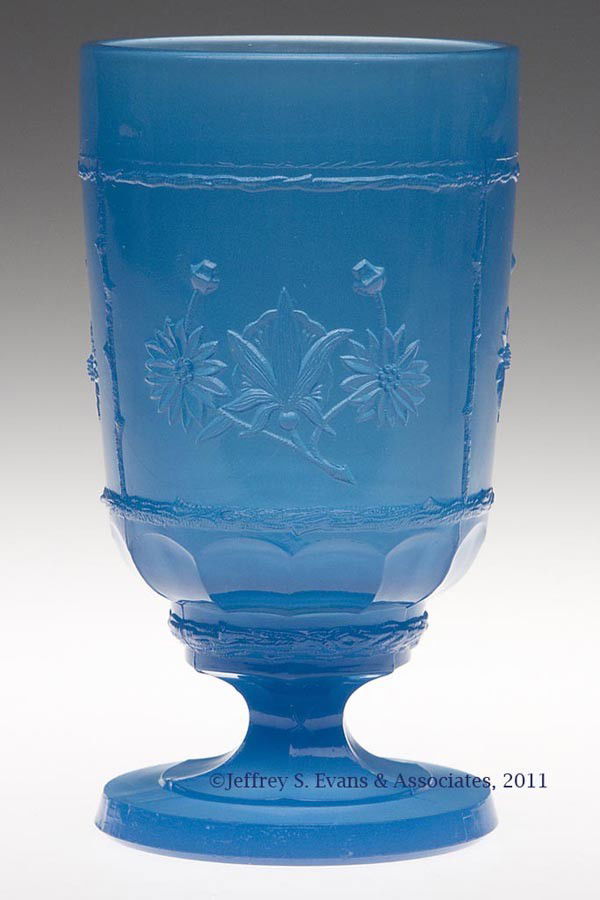 UNIDENTIFIED PRESSED FOOTED TUMBLER: UNIDENTIFIED PRESSED FOOTED TUMBLER, blue alabaster, featuring a floral design in three panels surrounding the bowl, each framed by slender branches, above twelve loops, raised on a hexagonal stem and