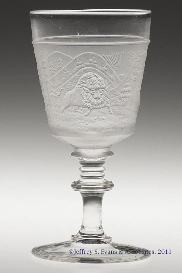 WESTWARD HO CHAMPAGNE GLASS: WESTWARD HO CHAMPAGNE GLASS, colorless and frosted. Gillinder & Sons. Fourth quarter 19th century. 5" H. Provenance: Personal collection of Judith (Judy) Cronin, Orleans, MA. Green Valley Auctions, In
