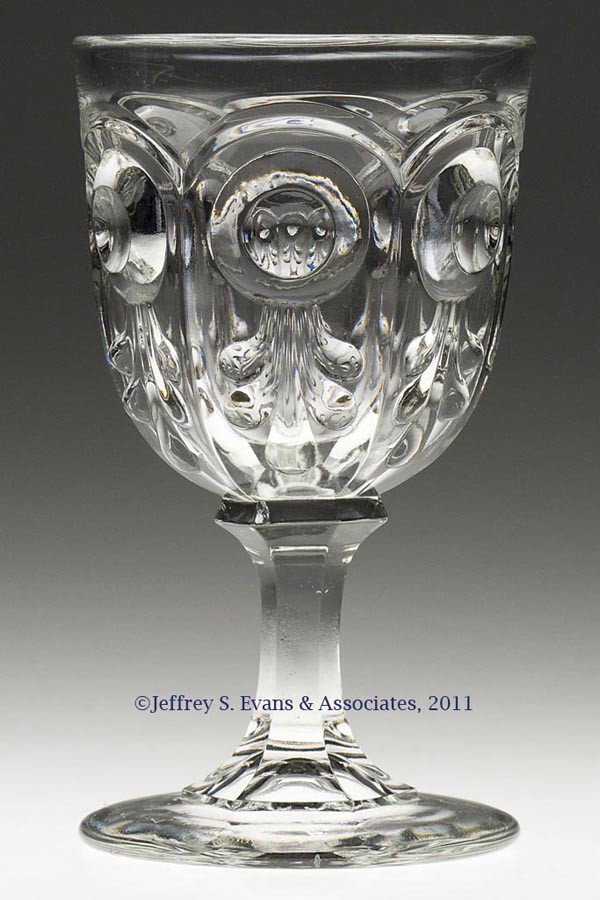 BULL'S EYE WITH FLEUR-DE-LYS GOBLET: BULL'S EYE WITH FLEUR-DE-LYS GOBLET, colorless lead glass. Third quarter 19th century. 6 1/4" H.