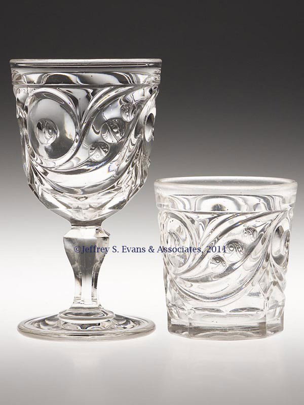 COMET DRINKING VESSELS, LOT OF TWO: COMET DRINKING VESSELS, LOT OF TWO, colorless lead glass, comprising a large goblet and a water tumbler, each with a polished pontil mark. Third quarter 19th century. 6 1/4" and 3 1/2" H.
