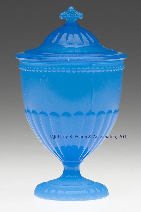 BEAD AND NARROW LOBE COVERED EGG CUP / POMADE: BEAD AND NARROW LOBE COVERED EGG CUP / POMADE, translucent starch blue with excellent resonance, lobes repeated on foot, cover and the delicate finial. Probably United States. Third quarter 19th centu