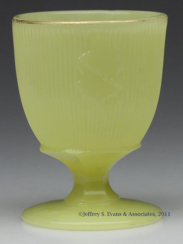 FINE RIB / REEDED (OMN) EGG CUP / POMADE: FINE RIB / REEDED (OMN) EGG CUP / POMADE, semi-opaque yellow green, with shield embossed "PHALON & SON", traces of gilt on rim. Boston & Sandwich Glass Co. and possibly others. Third quarter 19th cent