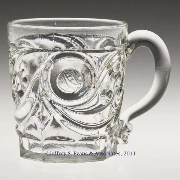 COMET LEMONADE / HANDLED WHISKEY: COMET LEMONADE / HANDLED WHISKEY, colorless lead glass, applied handle, polished pontil mark. Boston & Sandwich Glass Co. and probably others. Third quarter 19th century. 3" H, 2 5/8" D rim, 2 1/4" DO
