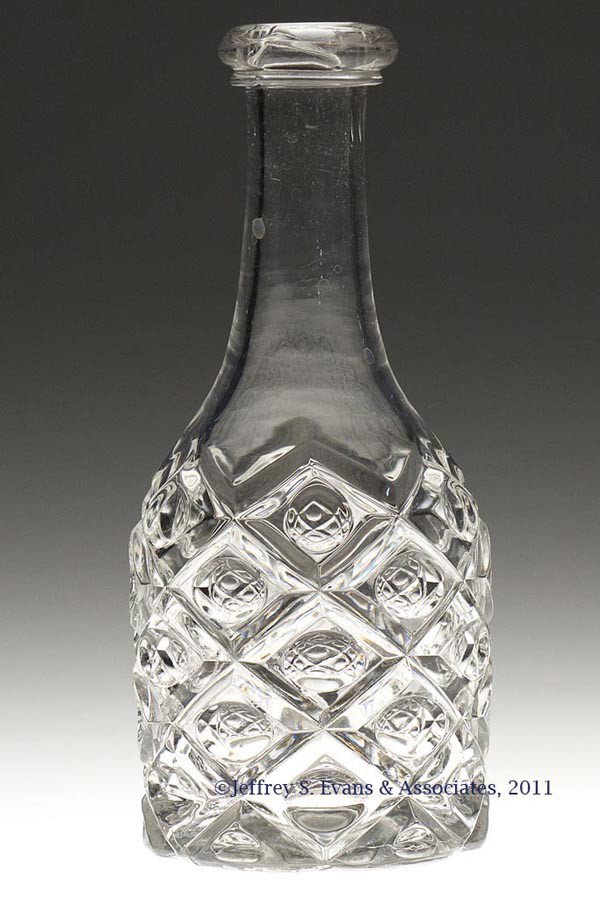 DIAMOND THUMBPRINT BITTERS BOTTLE: DIAMOND THUMBPRINT BITTERS BOTTLE, colorless lead glass, applied bar lip, polished pontil mark. Third quarter 19th century. 7" H, 2 7/8" D base.
