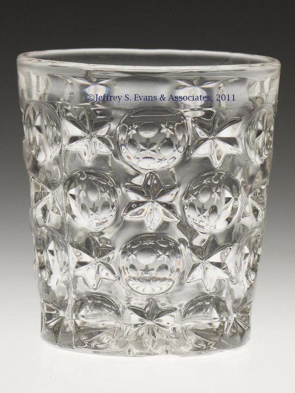 EARLY MOON AND STAR WATER TUMBLER: EARLY MOON AND STAR WATER TUMBLER, colorless lead glass, rayed base. Third quarter 19th century. 3 1/2" H, 3 1/8" D rim.