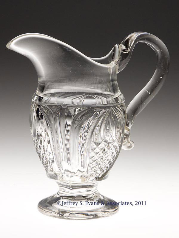 NEW ENGLAND PINEAPPLE CREAMER: NEW ENGLAND PINEAPPLE CREAMER, colorless lead glass with an unusual bluish opal tint, applied handle. Boston & Sandwich Glass Co. and others. Third quarter 19th century. 6 5/8" H lip, 3 1/4" D foot. P