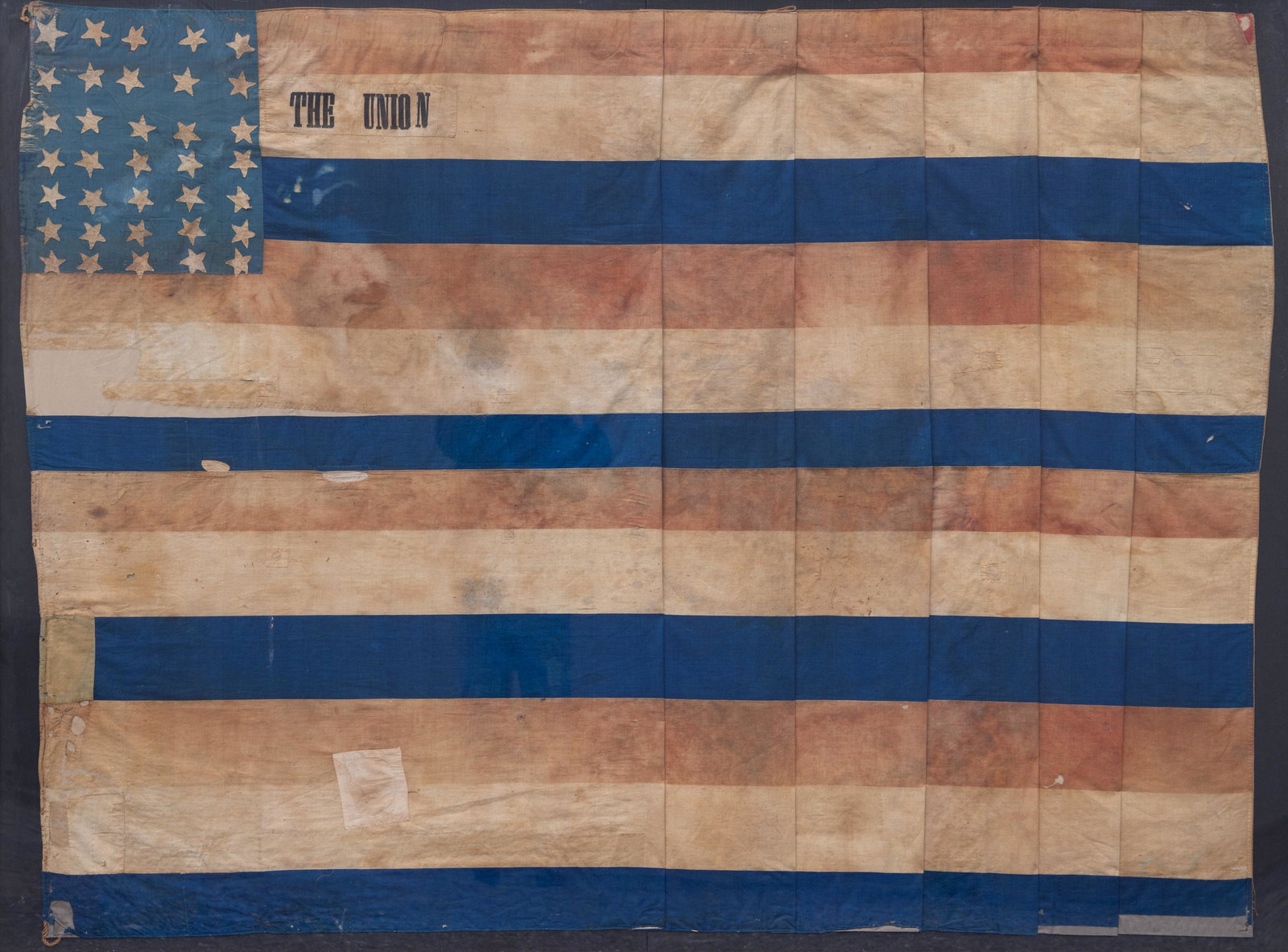 RARE AND IMPORTANT 35-STAR WEST VIRGINIA STATEHOOD CIVIL WAR-PERIOD FLAG BANNER: RARE AND IMPORTANT 35-STAR WEST VIRGINIA STATEHOOD CIVIL WAR-PERIOD FLAG BANNER, cotton linen throughout, undersized folky canton displaying slightly askew rows of five-pointed hand-sewn double-appliq
