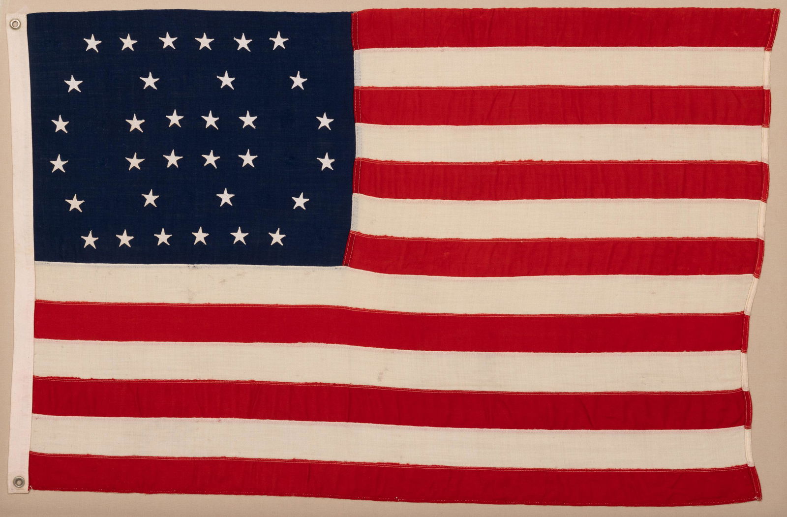 32-STAR MINNESOTA STATEHOOD AMERICAN NATIONAL FLAG: 32-STAR MINNESOTA STATEHOOD AMERICAN NATIONAL FLAG, machine-stitched wool with cotton stars, canton exhibiting very unusual stylized double wreath pattern. Conservation mounted in a modern frame. Poss