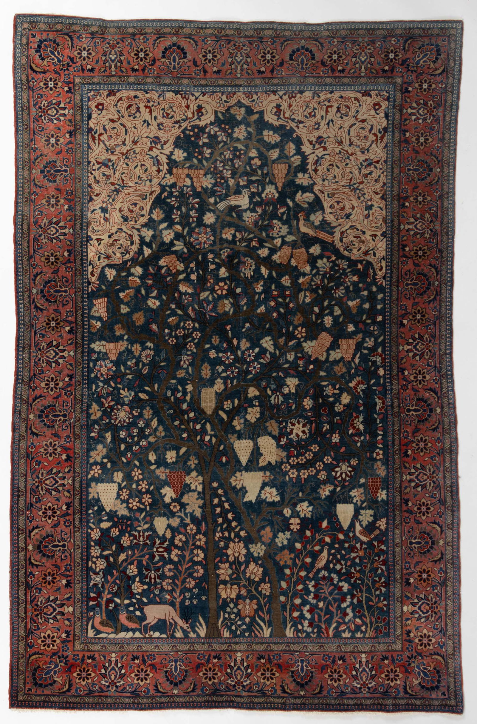 ANTIQUE PERSIAN "TREE OF LIFE" PICTORIAL RUG: ANTIQUE PERSIAN "TREE OF LIFE" PICTORIAL RUG, blue and red ground, featuring central tree with animal and bird figures. Late 19th/early 20th century. 7' 3/4" x 4' 6 1/2".Provenance: From the collectio
