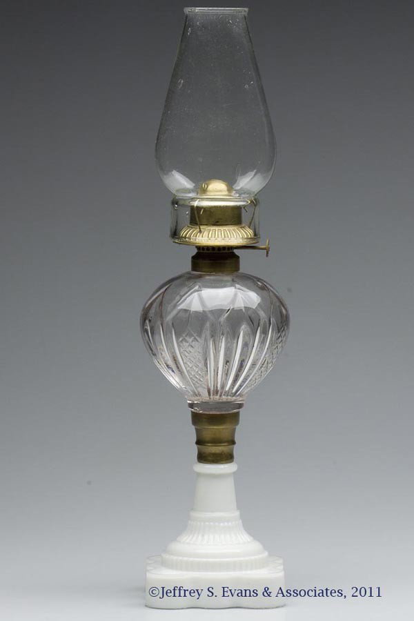 PANELED SPEARS UNDER GLASS STAND LAMP: PANELED SPEARS UNDER GLASS STAND LAMP, colorless font, opaque white No. 40 base, brass connector, No. 1 fine line collar. Fitted with a No. 1 period slip burner, thumbwheel marked "PATD. OCT. 29. 1867