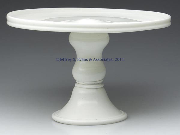 EUROPEAN FREE-BLOWN SALVER: EUROPEAN FREE-BLOWN SALVER, opaque white or enamel glass, the gallery-rim plate raised on a hollow hourglass-form stem and high domed foot with folded and tooled edge, rough pontil mark on interior. P
