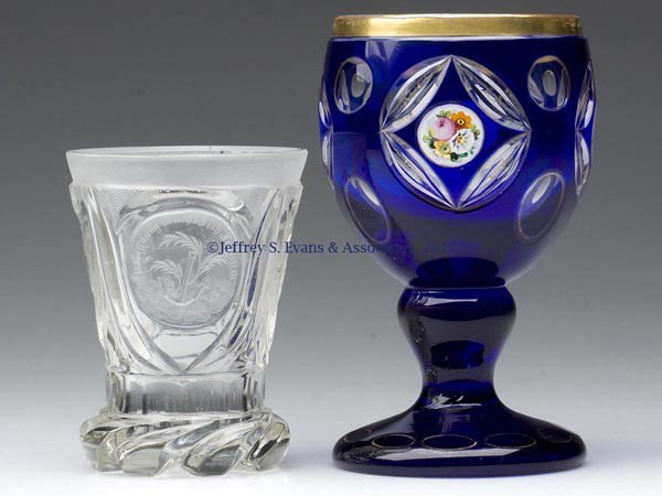 TWO EUROPEAN CUT DRINKING VESSELS: TWO EUROPEAN CUT DRINKING VESSELS, comprising a cobalt blue cut to colorless goblet with polychrome enamel and gilt decorations, and a colorless beaker with three engraved reserves featuring a pair of