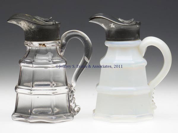 TWO BLOWN-MOLDED RINGED EIGHT-PANEL / BLOCK MOLASS: TWO BLOWN-MOLDED RINGED EIGHT-PANEL / BLOCK MOLASSES CANS / JUGS, deep fiery opalescent and colorless, each small-size tapered octagonal body featuring a medial ring, applied solid handle, and a plain