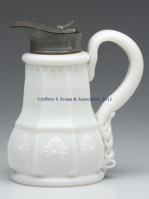 BLOWN-MOLDED DAISY PANELS MOLASSES CAN / JUG: BLOWN-MOLDED DAISY PANELS MOLASSES CAN / JUG, opaque white/milk glass, octagonal pyriform body with daisy panels surrounding the lower half, applied solid handle with an exceptionally complex lower te