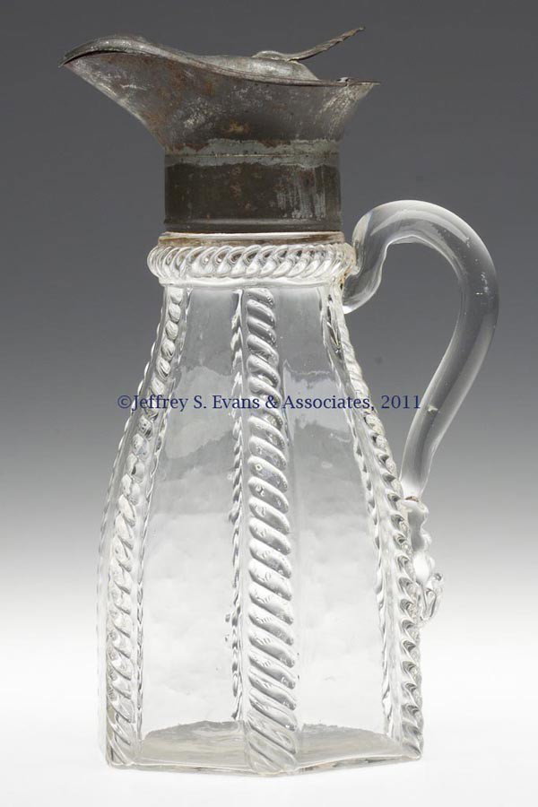 BLOWN-MOLDED CABLE MOLASSES CAN / JUG: BLOWN-MOLDED CABLE MOLASSES CAN / JUG, colorless, large tapered hexagonal body with the pattern covering each vertical corner and the neck ring, applied solid handle, plain base. Extremely rare. New E